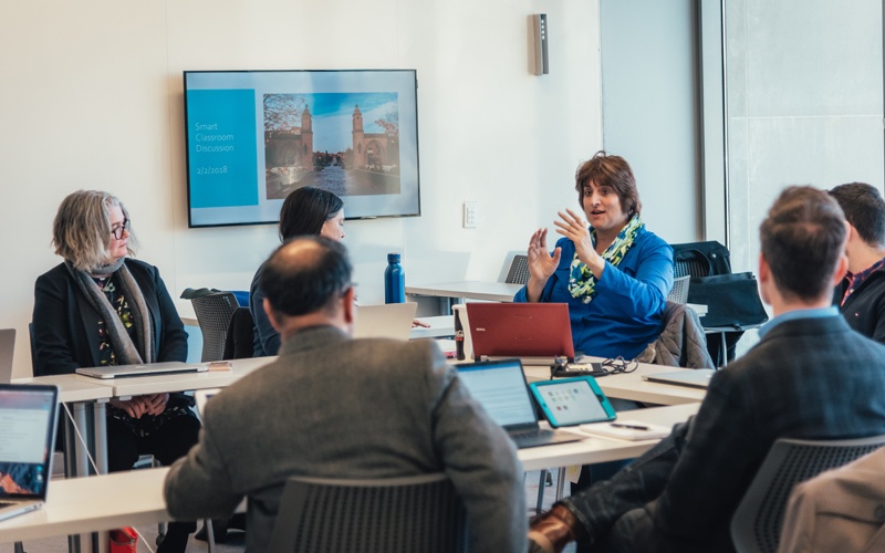 A group of Mosaic Faculty Fellows meeting in an active learning classroom
